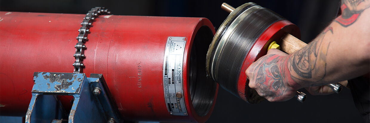 A technician preparing instruments and pressure vessels for safety testing.